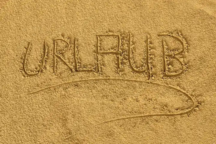 Urlaub - geschrieben in Sand. Das Wort: Urlaub, am Strand