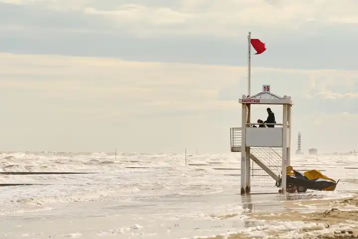 Lido di Jesolo, Italy - 2 May 2024: Red flag at the sea or beach of Lido di Jesolo. Swimming ban due to storms in the sea