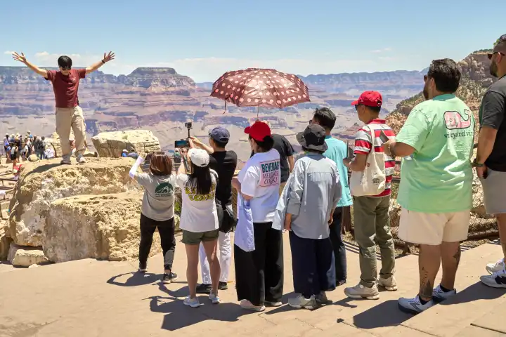 Arizona, United States of America - June 6, 2024: Visitors and tourists in the Grand Canyon National Park in the state of Arizona, USA. Popular hotspot on an American vacation. Tour group with Japanese and Chinese tourists