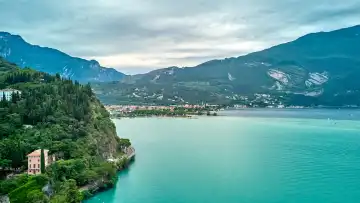 Riva del Garda, Lake Garda, Italy - June 24, 2024: Lake Garda from above in summer, with crystal clear water in the lake. Calm water between Torbole and Riva.