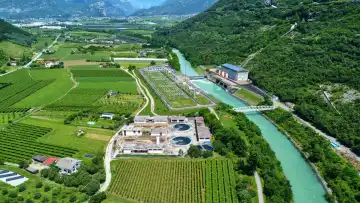 Nago Torbole, Lake Garda, Italy - June 25, 2024: Aerial view of the sewage treatment plant on the northern part of Lake Garda in Torbole, South Tyrol. Water treatment plant
