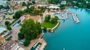 Riva del Garda, Lake Garda, Italy - June 25, 2024: A bird's eye view of Riva del Garada, with the MAG Museo Alto Garda. In the moat surrounded by the waters of Lake Garda, an absolute sight.