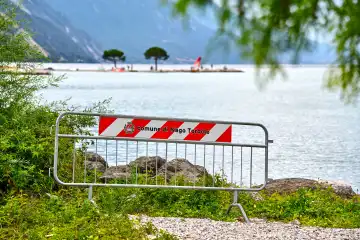 Torbole, Lake Garda, Italy - June 25, 2024: Barrier on the beach of Lake Garda in the municipality of Nago-Torbole. Barrier fence is set up in front of the water.