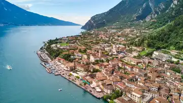  Limone sul Garda, Lake Garda, Italy - June 26, 2024: Aerial view of the town of Limone sul Garda on the shores of Lake Garda in Italy. View of the town surrounded by mountains and crystal clear waters of Lake Garda