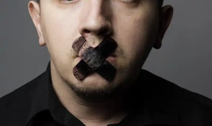 Man with Mouth Covered by Black Patch to Forbidden Him the Free Speeching
