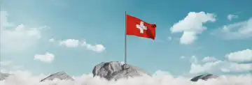 Waving Swiss flag above the sea of clouds on National Day on August 1