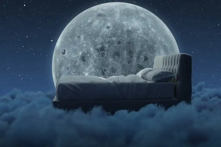 Gemütliches Bett über flauschige Wolken in der Nacht. Beleuchtet vom großen Mond