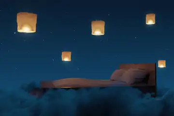 Cozy bed illuminated by sky lanterns. The bed flies over fluffy clouds in the night