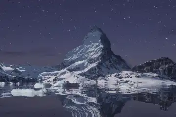 The majestic Matterhorn reflected on the lake on a starry night