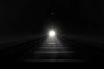 Dark train tunnel with a bright light at the end