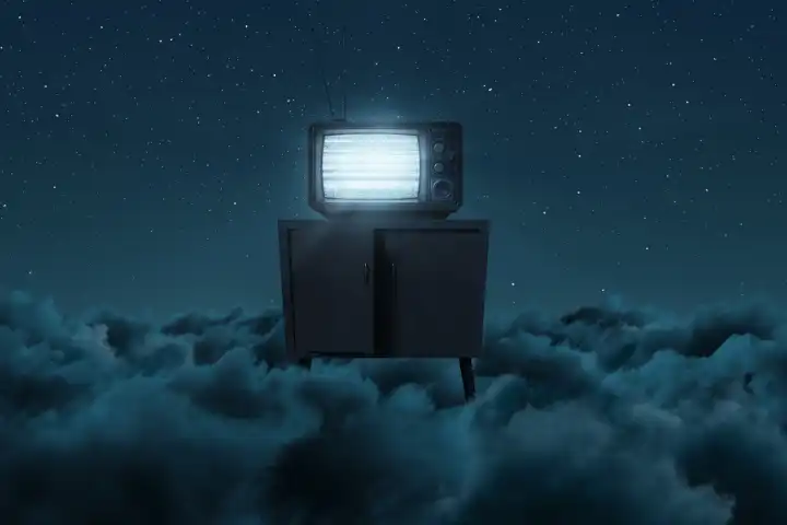 Old TV with bright, static screen above the night clouds