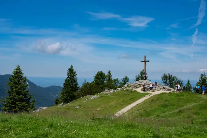 Aschau, Bavaria, Germany - July 14, 2020: Tourists visit the devotional summit cross on the Kampenwand mountain, Bavaria