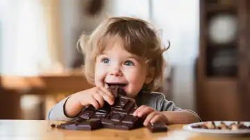 Toddler eating a lot of dark chocolate, generated with AI