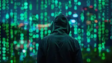 ai generative illustration of unrecognizable man in a dark hoodie stands in front of a large screen with green digital lettering, symbolic representation of a hacker