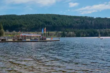 Titisee, Germany - April 06, 2024: Tourists on excursion boat at the Titisee. The Titisee is a charming lake located in the southern Black Forest in Baden-Württemberg, Germany.