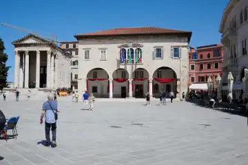 Pula, Istrien, Kroatien - 23. Mai 2024: Touristen auf einem Platz vor dem historischen Rathaus von Pula, Kroatien.