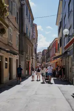 Pula, Istria, Croatia - May 23, 2024: Tourists on sightseeing and shopping in the old town of Pula, Croatia.