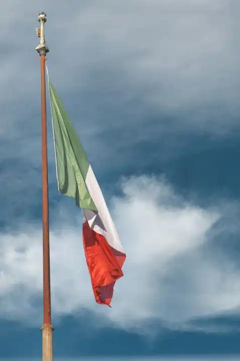 The Italian flag flies in the sky