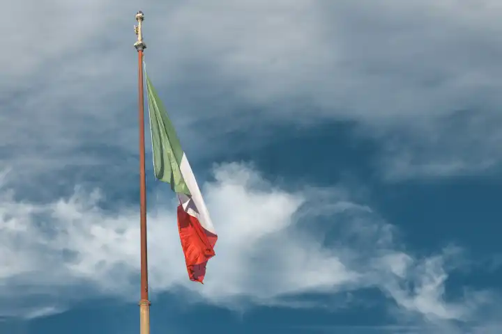 The Italian flag flies in the sky