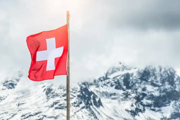 Swiss flag in the Alps of engadine valley
