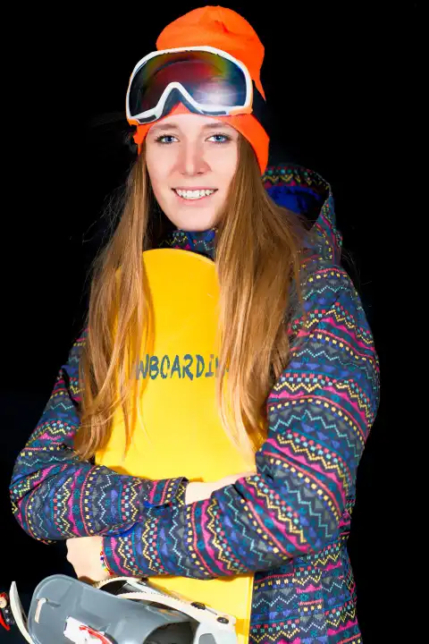 blond girl with long hair with snowboard and winter sportswear in studio.