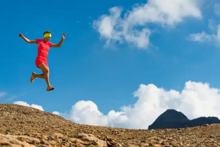 Girl makes a jump while running in the mountains