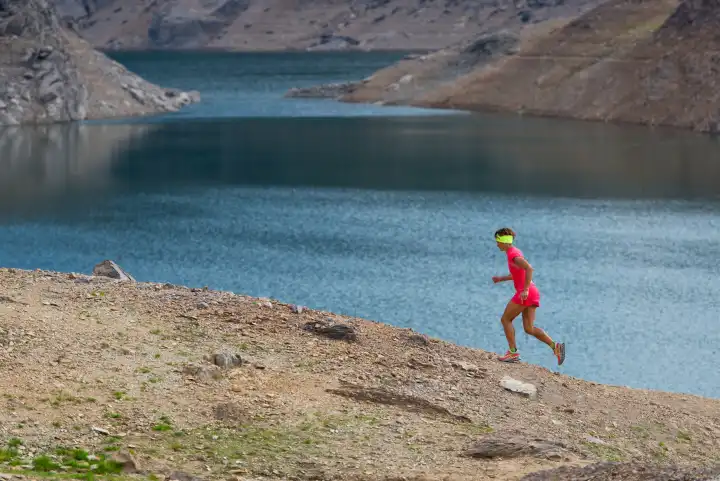 Girl runs from alpine lakes in large areas of mountain