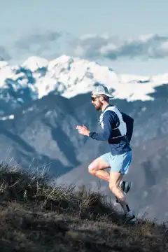 A man running in the mountains in the Italian Alps