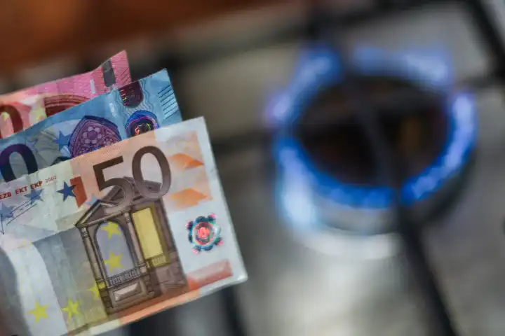 Image about expensive energy with Euro money and lit gas stove