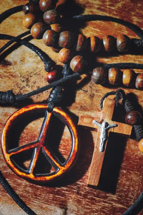 Symbol des Friedens und das Kruzifix auf einem Holztisch