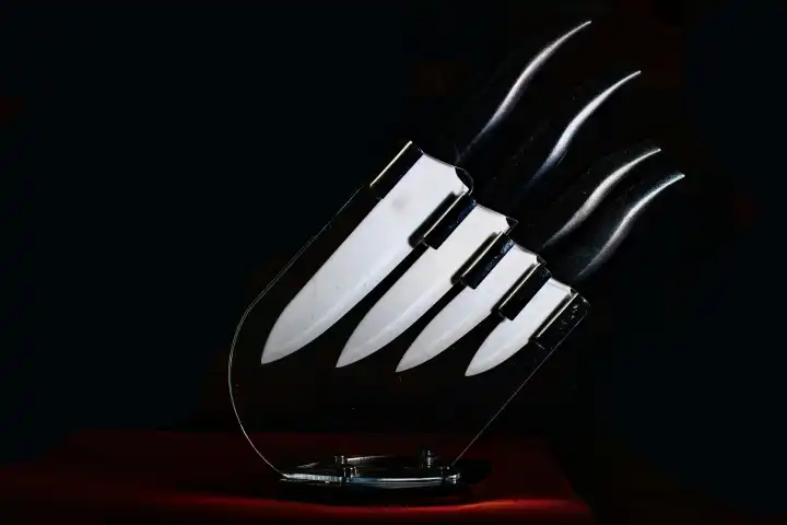 Knife set with ceramic blades on dark background