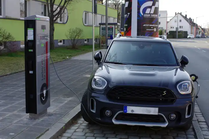 Electromobility: E-car is charged at a public charging station