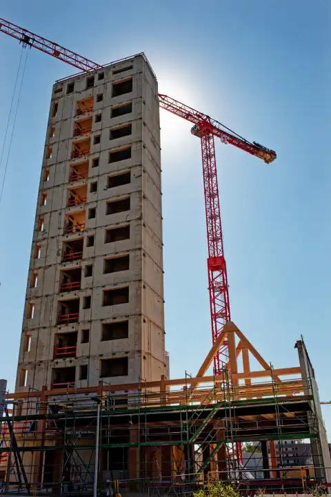 Construction industry, half finished shell of a building with crane