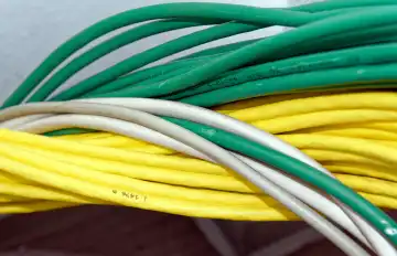 Background, detail, networking: Bundles of interlaced, multicoloured network cables