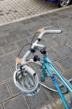 Safety in traffic: bicycle helmet hanging on the handlebars of a bicycle