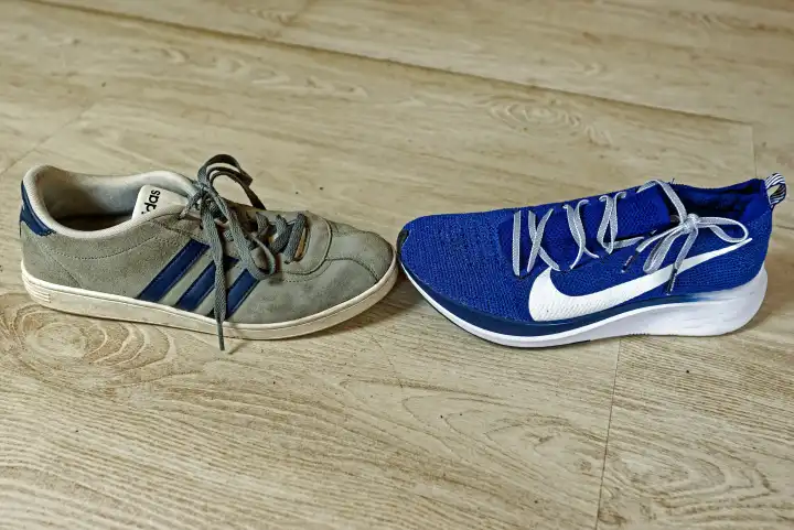 Sports shoes from Adidas and Nike meet at the tip of the shoe