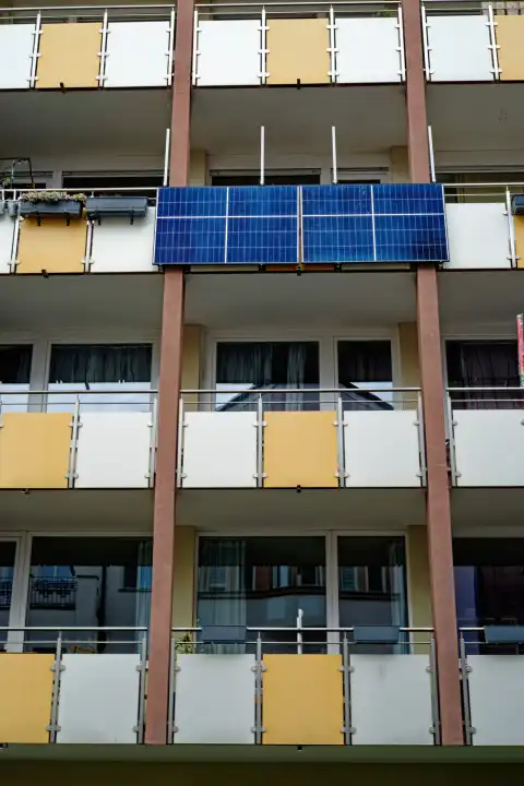 Balcony power plant, photovoltaic elements on a residential building façade with balconies