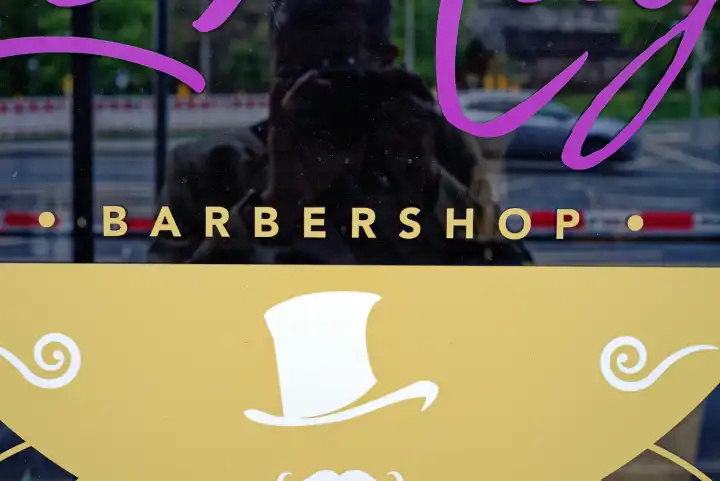 Advertising for a barbershop on a shop window