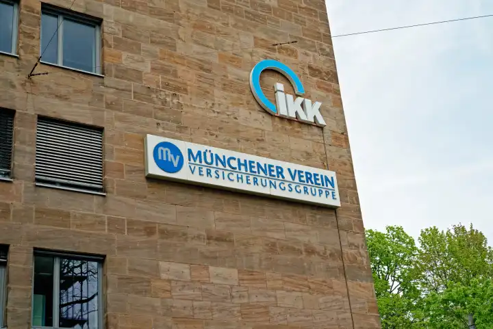 Lettering of the health insurance company IKK and the insurance company Münchner Verein on a building facade