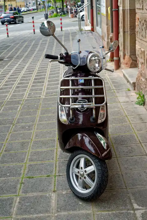 Front view of a black scooter with luggage rack