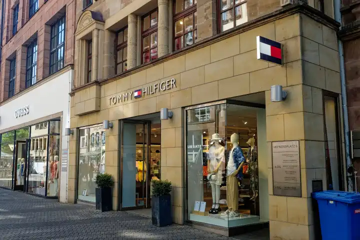 Lettering of the fashion retailers Hilfiger and Guess on the facade of a store in Nuremberg, Bavaria, Germany