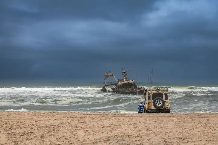 Deep sea fishermen at the wreck of the fishing vessel Zeila, Skeleton Coast, Namibia