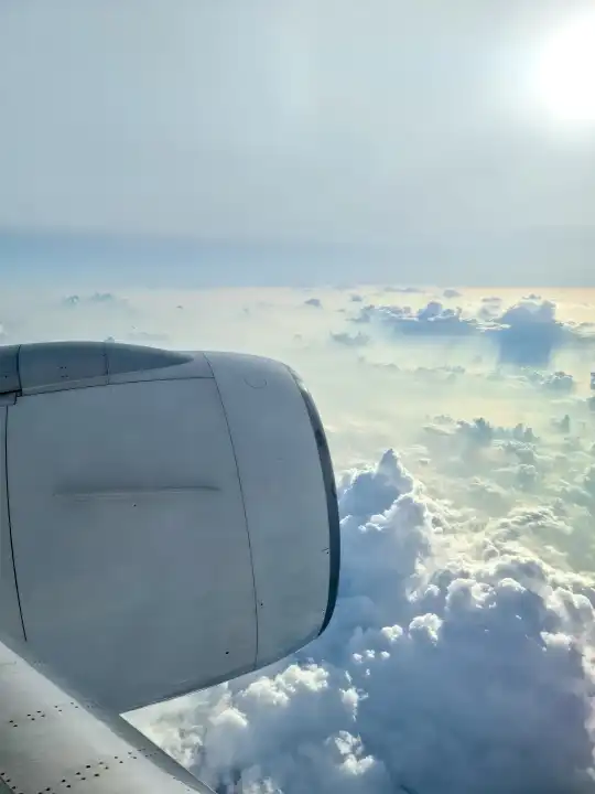 View from an airplane of the engine and the clouds over the Maldives
