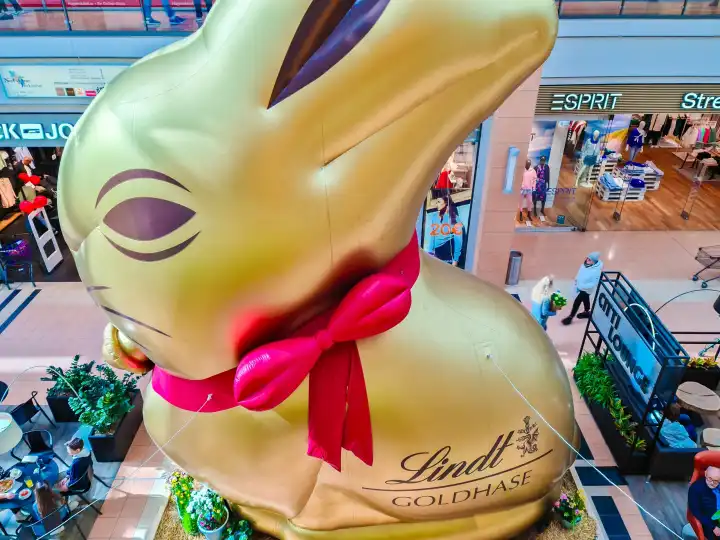 Kiel, Germany - 01. April 2024: A giant golden bunny from the Lindt chocolate brand in a shopping center