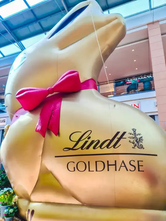 Kiel, Germany - 01. April 2024: A giant golden bunny from the Lindt chocolate brand in a shopping center