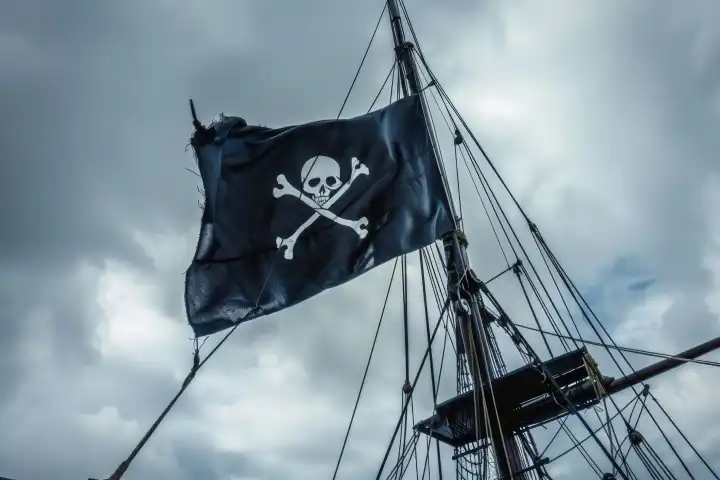 Eine schwarze Piratenflagge am Mast eines Segelschiffs, AI-generiert