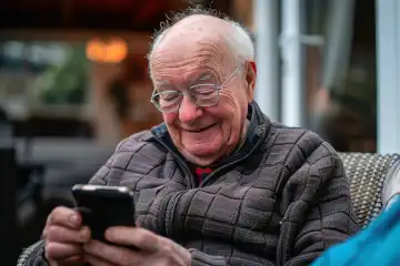 A pensioner enjoying the new smartphone, generated with AI