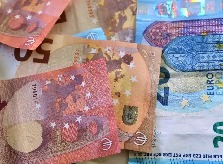 Close up of numerous euro banknotes lying on top of each other