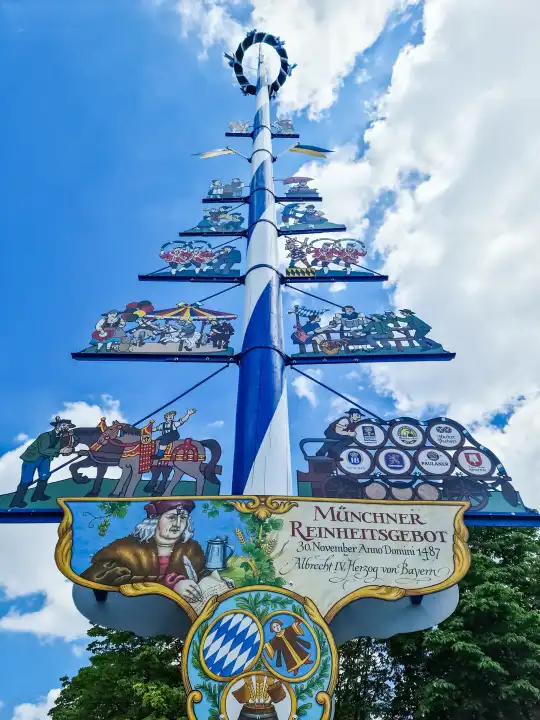 Munich, Germany - 22 June 2024: The famous large maypole at the Viktualienmarkt in the centre of Munich