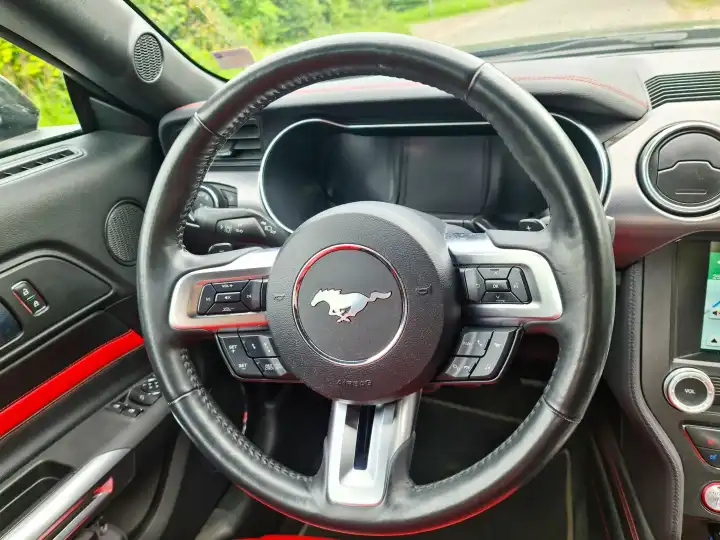 Kiel, Germany - 26 June 2024: A red leather interior in the cockpit of a 2018 Ford Mustang model